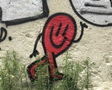Graffiti d'un bonhomme rouge qui fait coucou